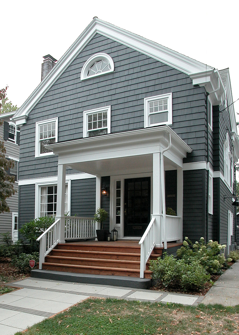 Traditional style home with dark gray siding and white trim