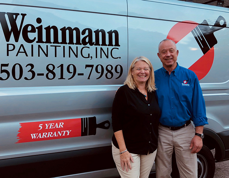 Portrait of owners Lori and Kevin in front of a Weinmann painting van