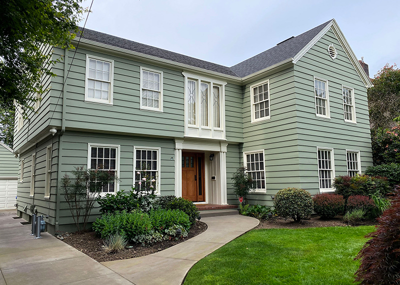 Two story light green home.