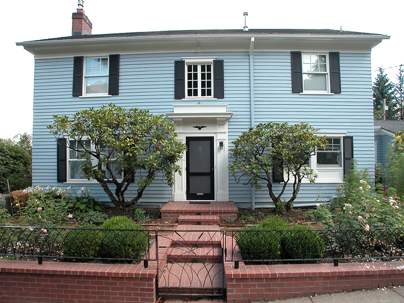 Wide shot of a two story light blue house